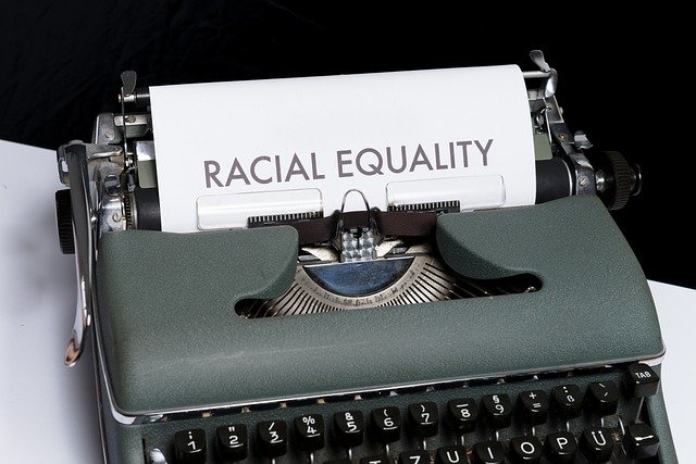 Type writer with paper saying Race Equality